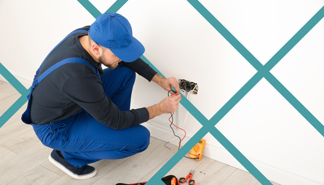 Electrician-working-in-home-SEO Electrician wiring an electrical outlet inside a residential home