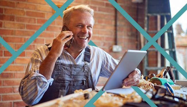 Happy-Local-Service-Business-Owner-with-Lead-Generation Happy local service business owner talking on the phone and holding a tablet while receiving leads