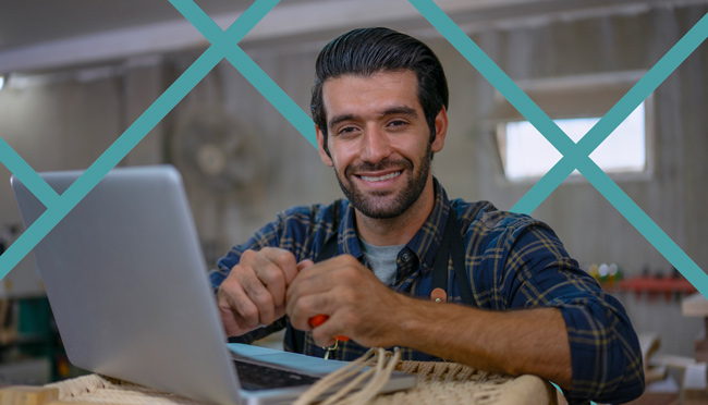 Happy local service business owner reviewing schema markup results on a laptop